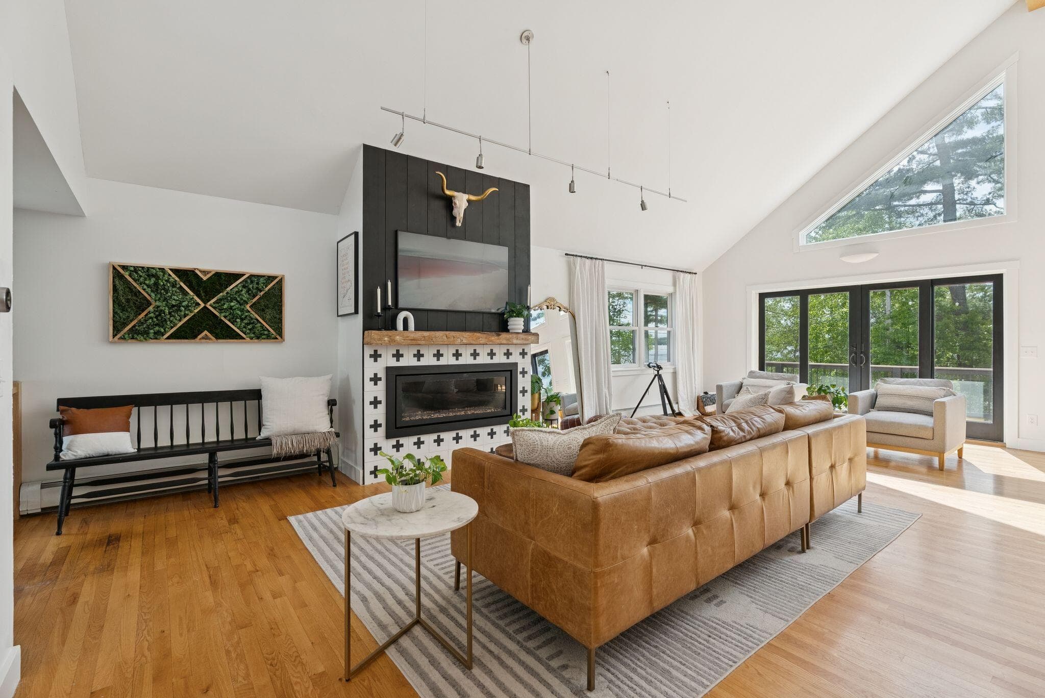 A minimalist, professionally staged living room with neutral furniture and natural light.